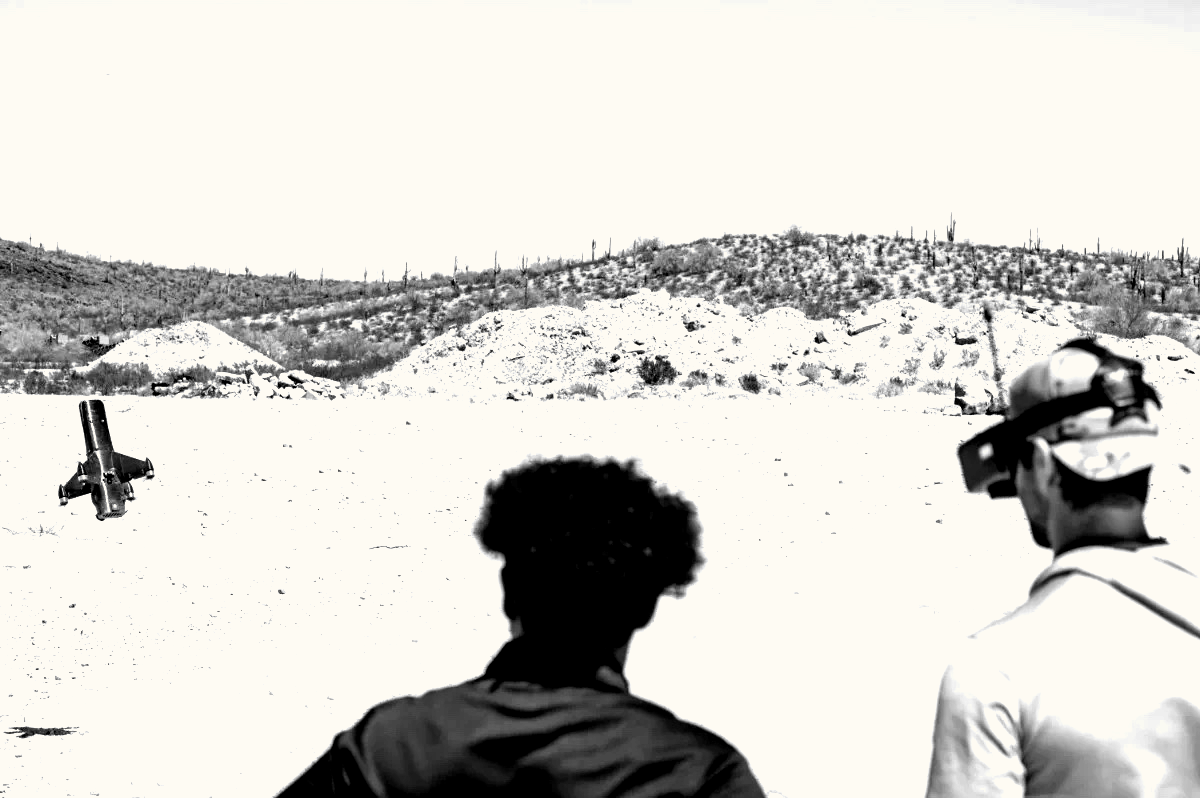 Operators watching an interceptor drone in the desert